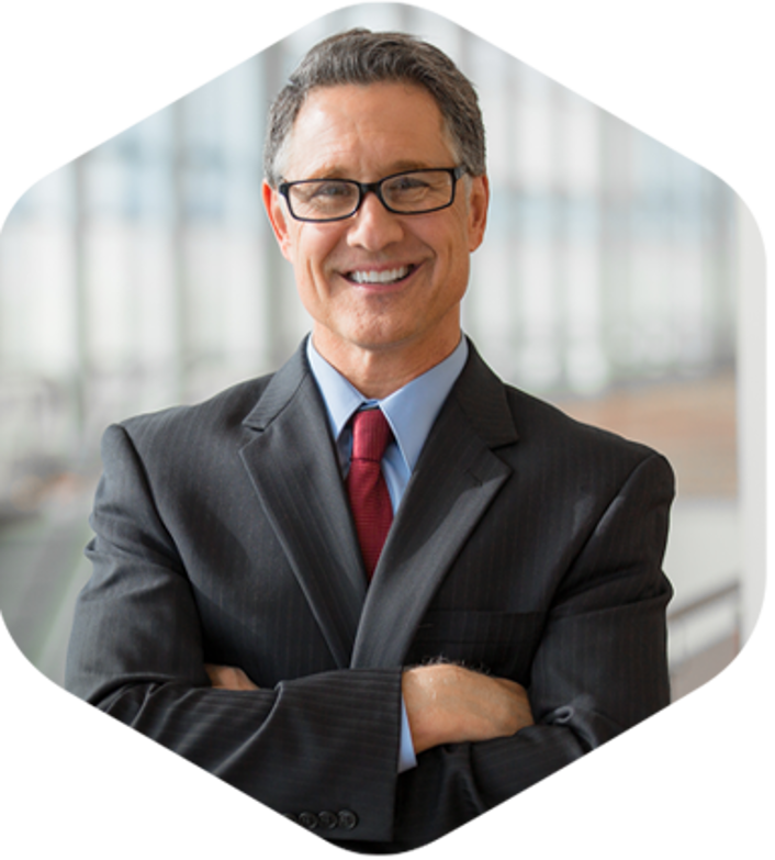 A professional man wearing a suit and tie with a pleasant expression on his face.